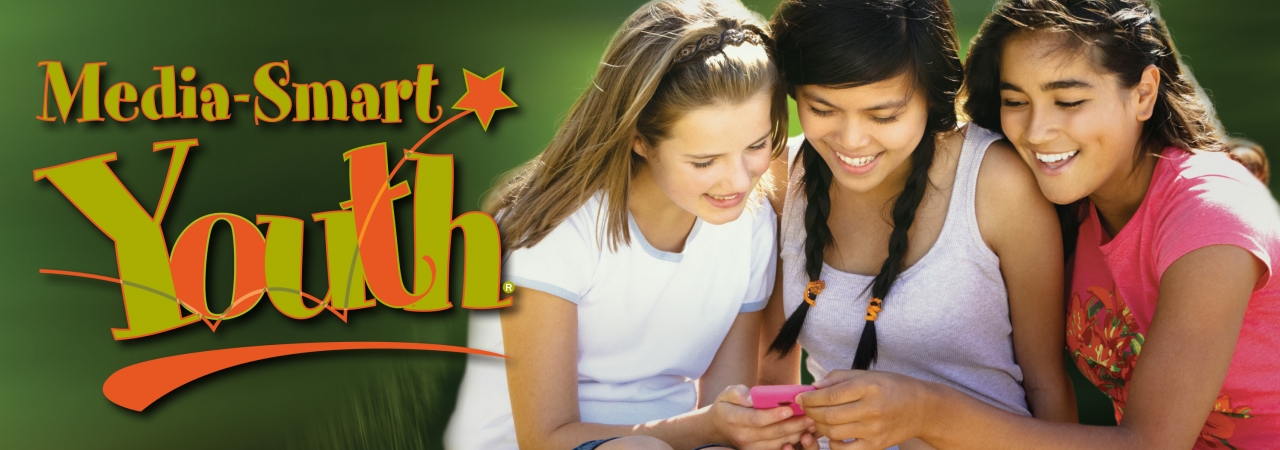Read "Fostering Media-Smart Youth". Three young girls smiling with the words Media Smart Youth.