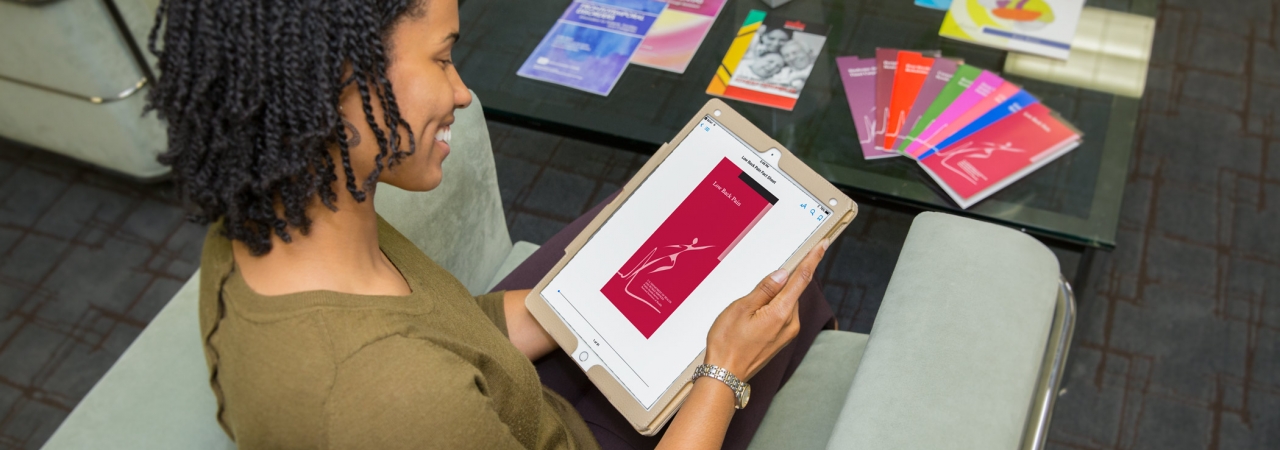 A woman using a tablet.