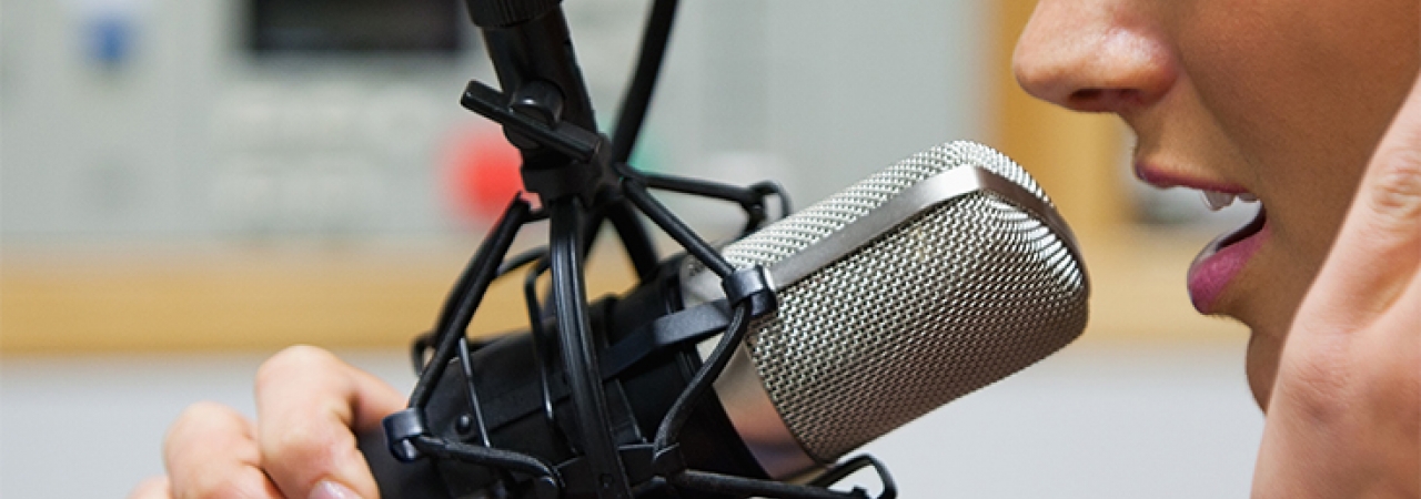 A woman speaking into a microphone.