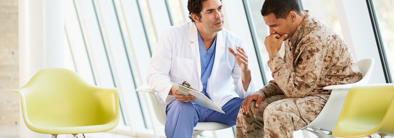 Read "Harnessing Mobile Technology to Prevent Suicide". doctor talking to military personnel