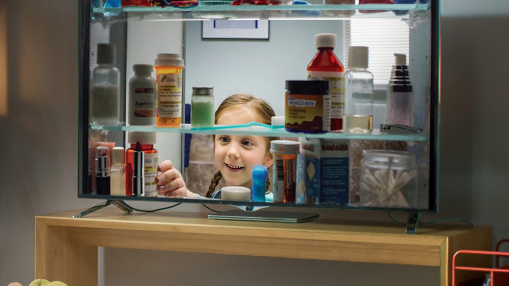 Young person grabbing medicine in cabinet as part of a FDA ad
