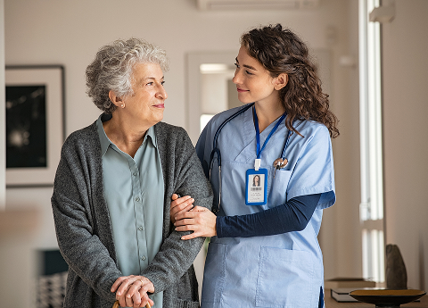 Nurse holding arm of patient and providing support in medical setting