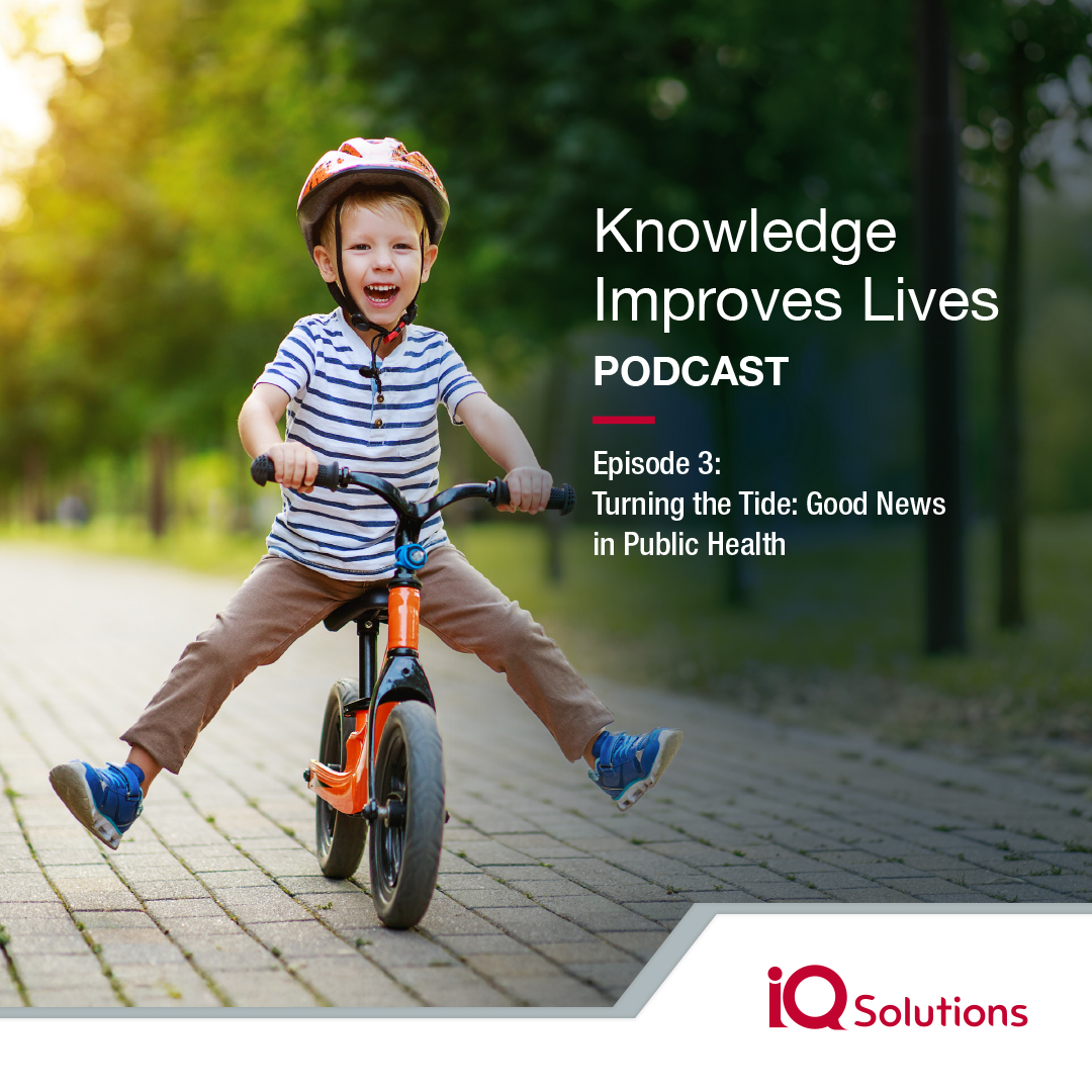 Smiling child riding bike, with overlay text which reads, "Knowledge Improves Lives Podcast, Episode 3: Turning the Tide: Good News in Public Health" and the IQ Solutions logo. 