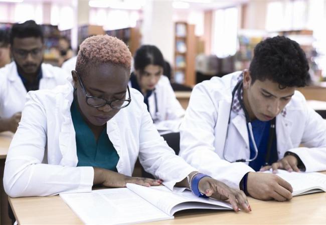 Nurses sitting in a classroom and reading medical literature