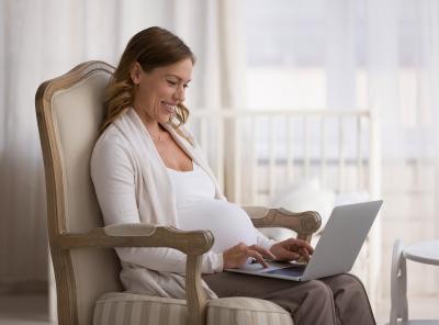 Pregnant woman on a telehealth visit on laptop