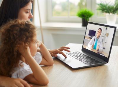 Mother and child speaking with doctor over a video call.