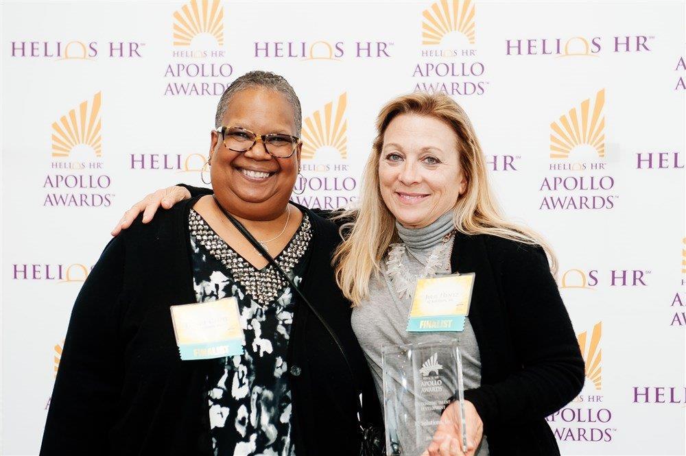 Two iq solutions team members at an award ceremony